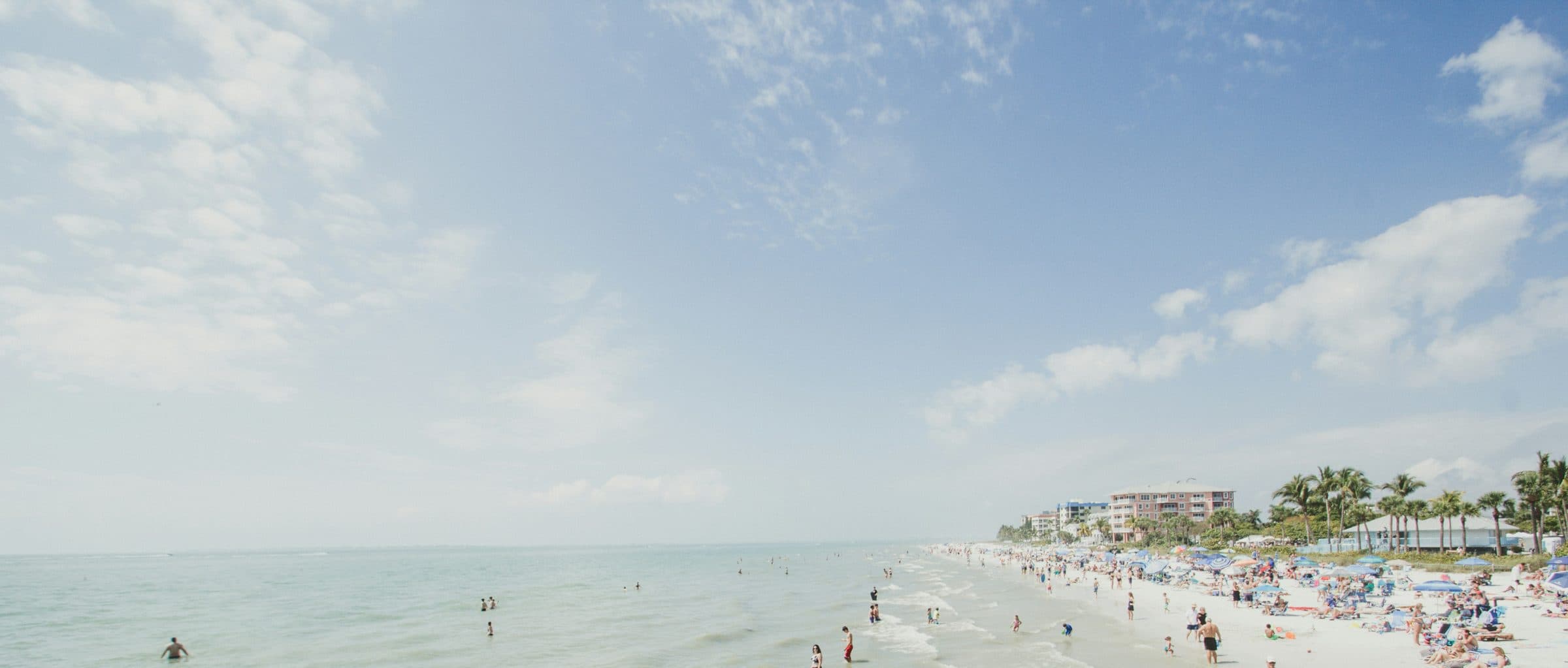 Blue sky over turquoise water and the beach at Fort Myers Beach